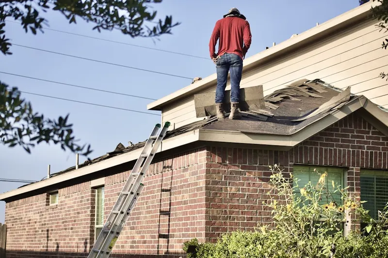 Professional roofer working on a residential roof in Seneca West
